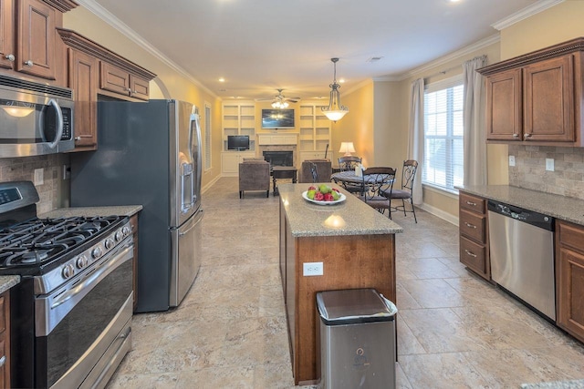 kitchen with light stone countertops, a center island, stainless steel appliances, and tasteful backsplash