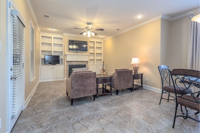 living room featuring built in shelves, ceiling fan, and crown molding