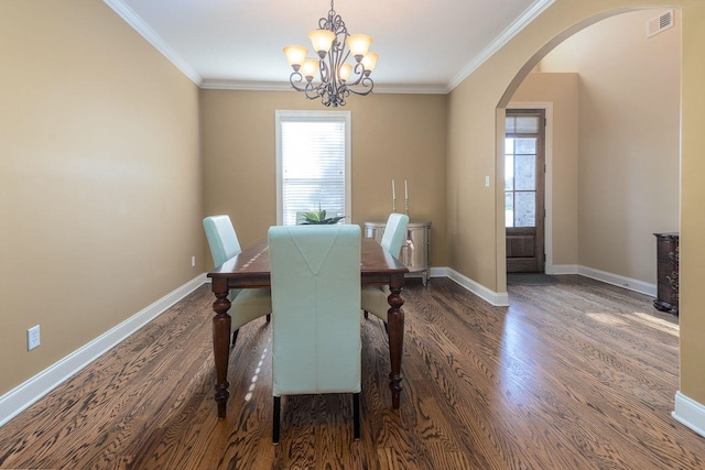 dining space with dark hardwood / wood-style floors, plenty of natural light, and ornamental molding