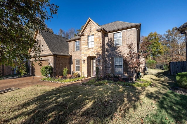 view of front of property featuring a front lawn and a garage