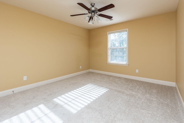 spare room featuring ceiling fan and light colored carpet