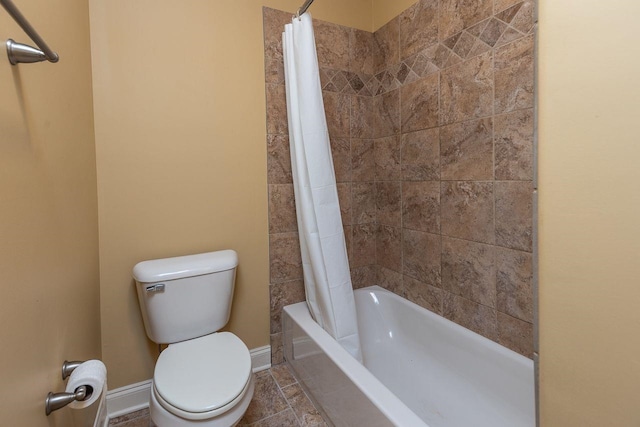 bathroom with toilet and shower / bath combo with shower curtain