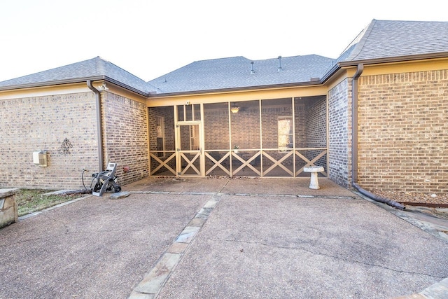 rear view of property with a sunroom