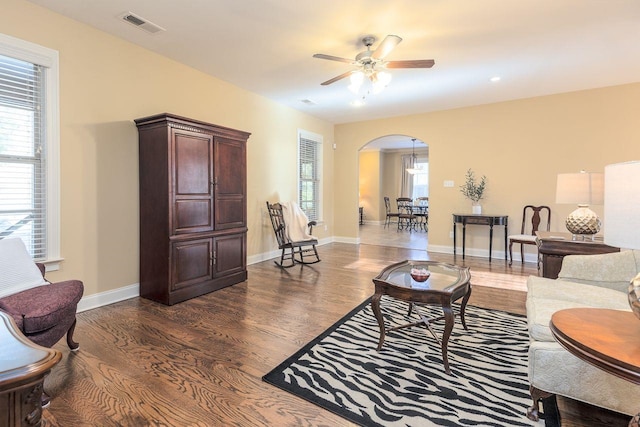 living room featuring dark hardwood / wood-style floors and ceiling fan