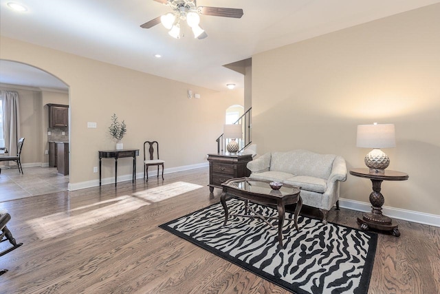 living room featuring ceiling fan and hardwood / wood-style flooring