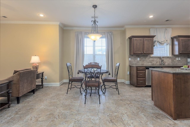 kitchen featuring dark brown cabinetry, hanging light fixtures, stainless steel dishwasher, decorative backsplash, and ornamental molding