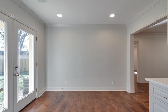 unfurnished dining area featuring dark hardwood / wood-style floors and crown molding