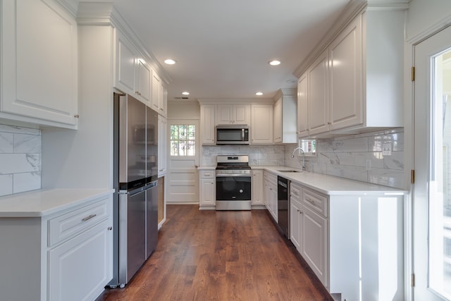 kitchen featuring white cabinets, dark hardwood / wood-style floors, sink, and appliances with stainless steel finishes