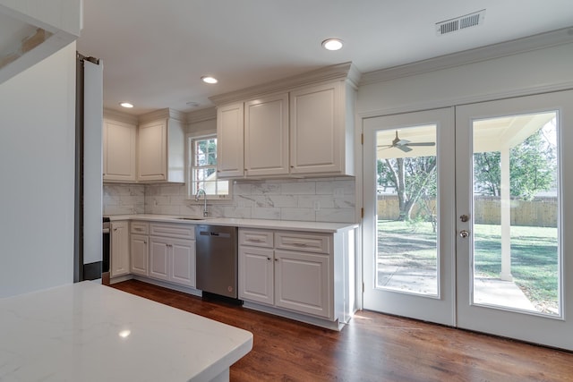 kitchen featuring dishwasher, white cabinetry, and a healthy amount of sunlight