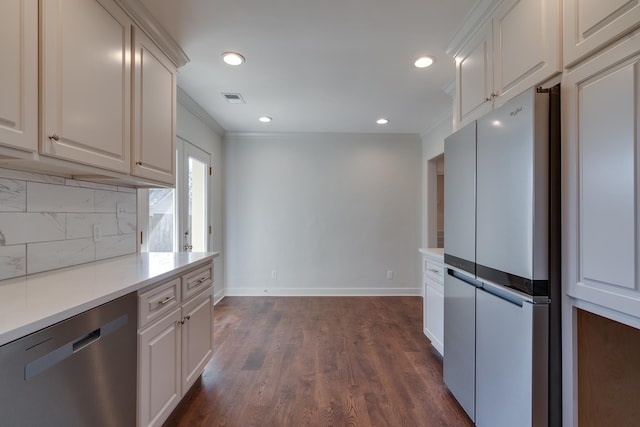 kitchen with crown molding, white cabinets, and stainless steel appliances