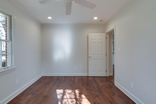 spare room with crown molding, ceiling fan, and dark wood-type flooring