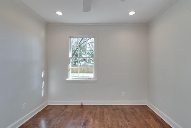 empty room with dark hardwood / wood-style flooring and crown molding