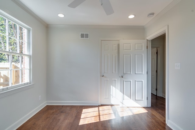 interior space featuring ceiling fan, ornamental molding, and dark wood-type flooring