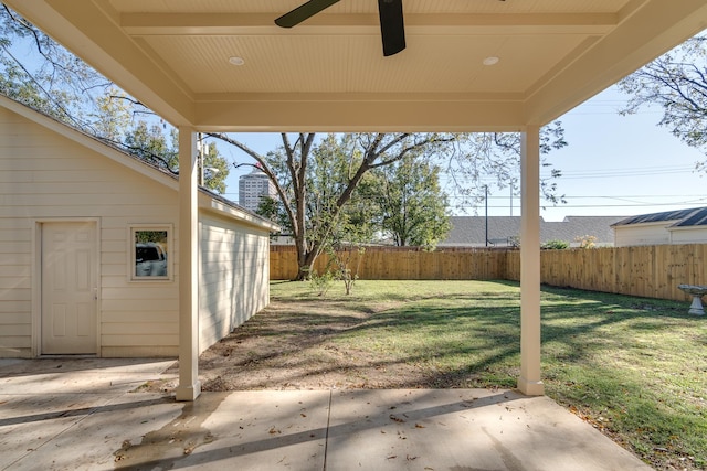 view of yard with ceiling fan and a patio area