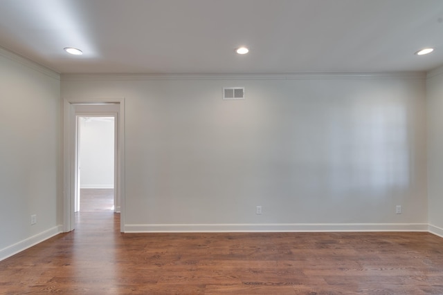 unfurnished room with dark hardwood / wood-style floors and crown molding