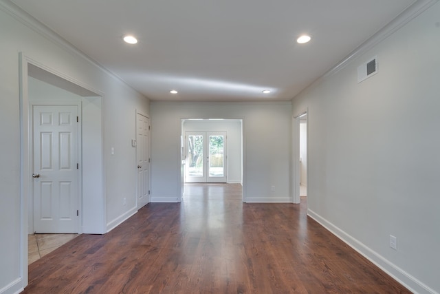 spare room with dark hardwood / wood-style flooring, ornamental molding, and french doors