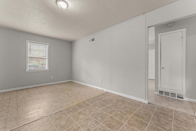 unfurnished room featuring a textured ceiling