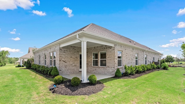 view of property exterior featuring a lawn and a patio