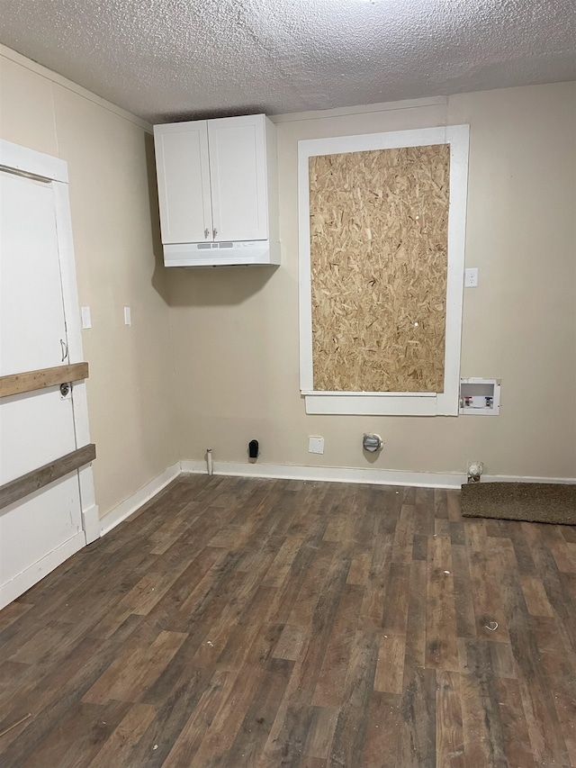 laundry area with dark hardwood / wood-style flooring, a textured ceiling, and hookup for a washing machine