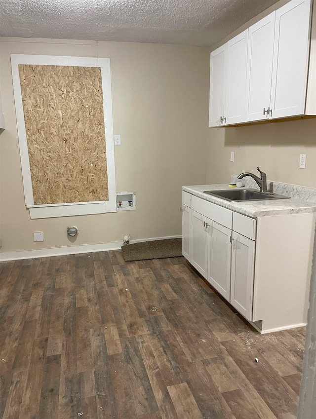 washroom featuring washer hookup, a textured ceiling, dark wood-type flooring, and sink