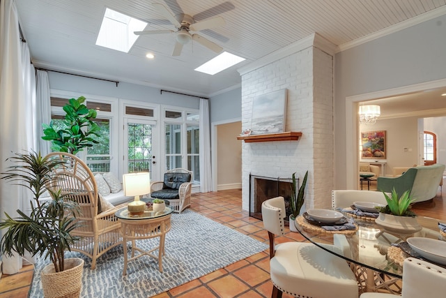 tiled living room featuring a brick fireplace, ceiling fan, and ornamental molding