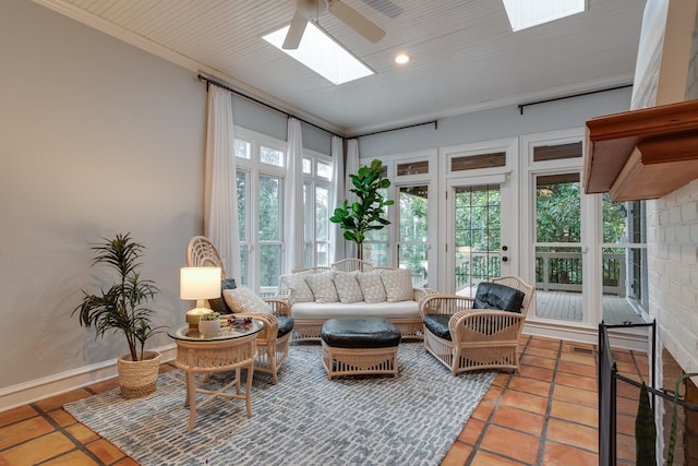 sunroom with a skylight and ceiling fan