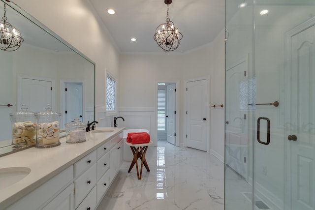 bathroom featuring a shower with door, ornamental molding, and an inviting chandelier