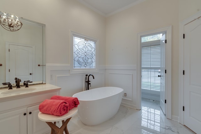 bathroom featuring a bathing tub, vanity, crown molding, and a chandelier