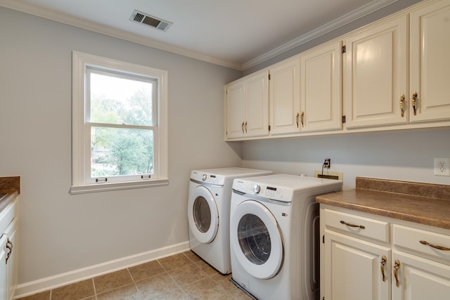 clothes washing area featuring cabinets, light tile patterned floors, crown molding, and washing machine and dryer