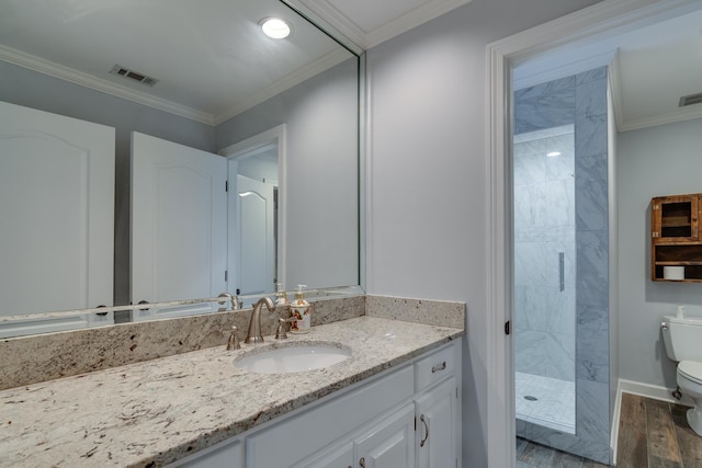 bathroom with tiled shower, toilet, wood-type flooring, and ornamental molding