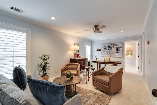 carpeted living room featuring ceiling fan and crown molding