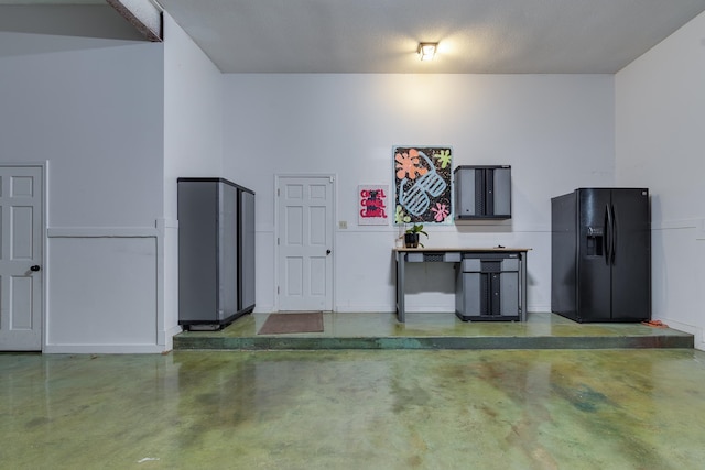 garage with black fridge