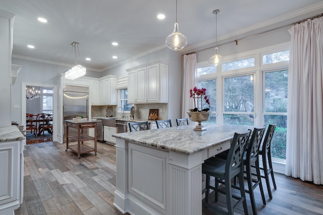 kitchen with pendant lighting, a center island, and a wealth of natural light