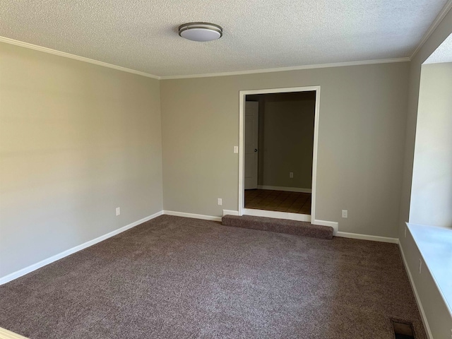 carpeted spare room featuring a textured ceiling and ornamental molding