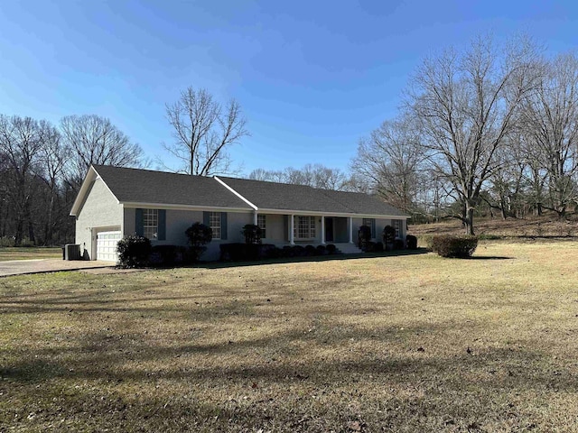 ranch-style home featuring a garage and a front lawn