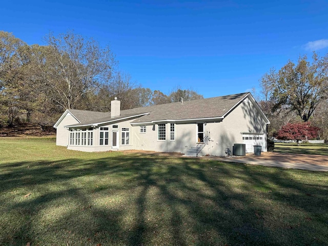 rear view of house featuring a lawn and central air condition unit