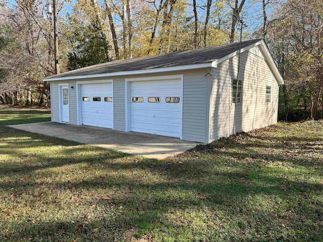 garage featuring a lawn