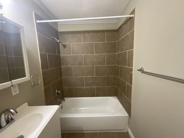 bathroom featuring tiled shower / bath combo, a textured ceiling, and vanity