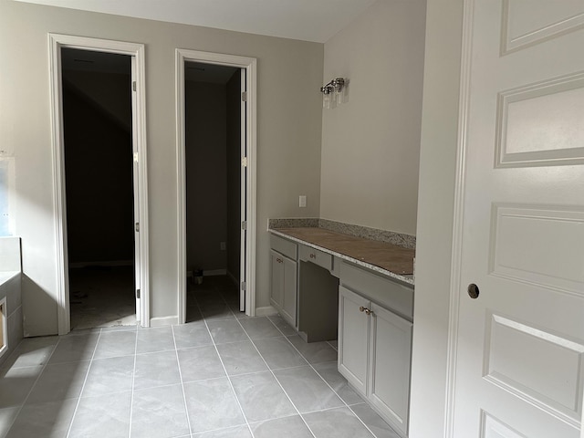 bathroom with tile patterned flooring and vanity