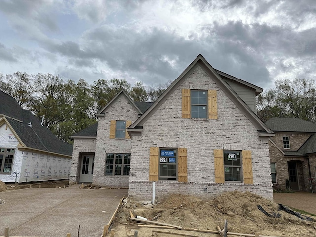 rear view of house featuring brick siding