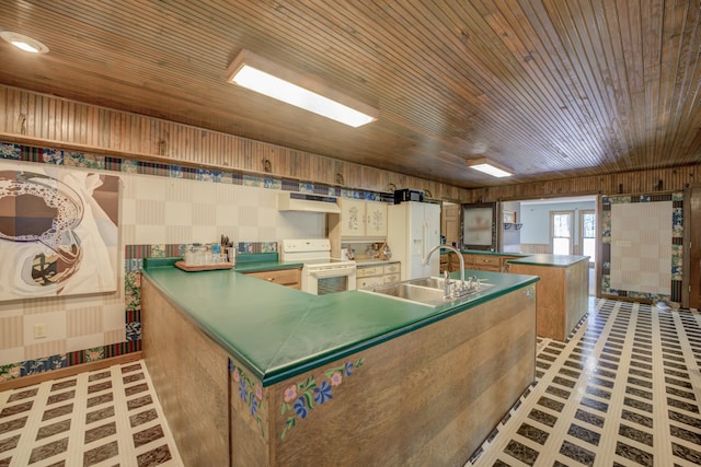 kitchen with custom exhaust hood, white appliances, french doors, sink, and an island with sink