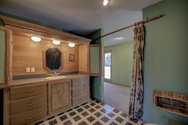 bathroom with vanity and a textured ceiling