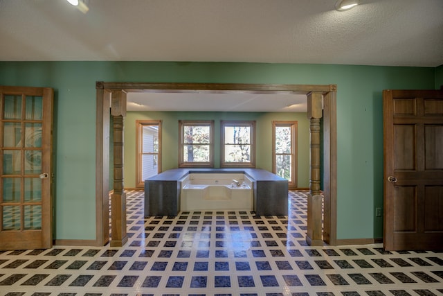 bathroom with a textured ceiling and a bathing tub