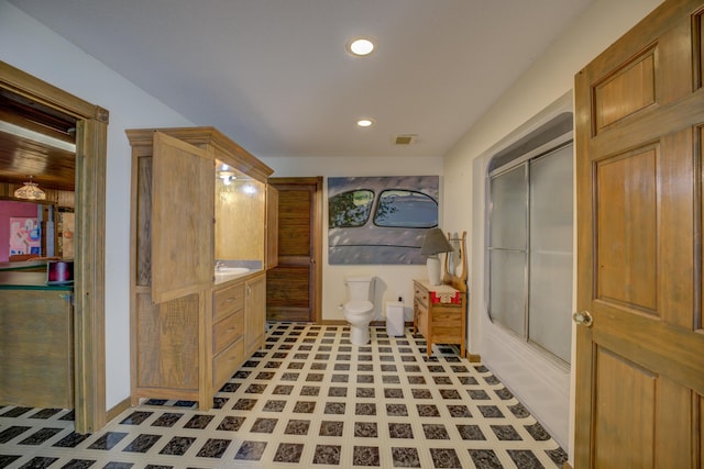 full bathroom featuring vanity, toilet, and combined bath / shower with glass door