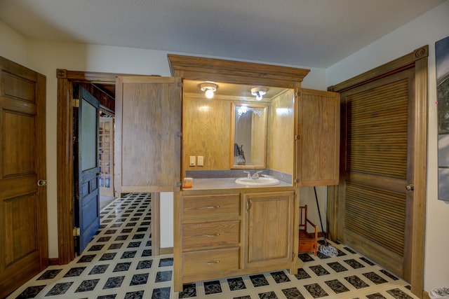 bathroom with a textured ceiling and vanity