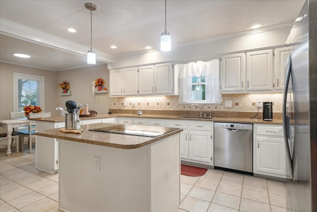 kitchen featuring stainless steel appliances, white cabinetry, hanging light fixtures, and a kitchen island