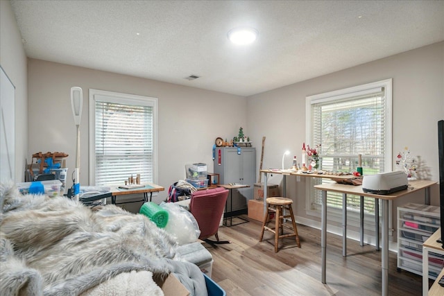 bedroom featuring a textured ceiling and light wood-type flooring