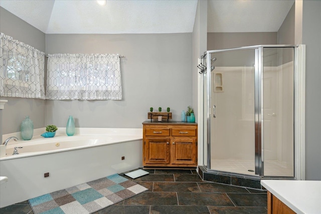 bathroom with vanity, a textured ceiling, and shower with separate bathtub