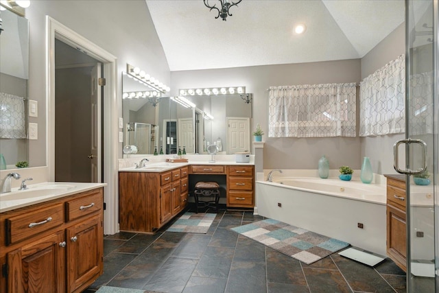 bathroom featuring shower with separate bathtub, vanity, and vaulted ceiling