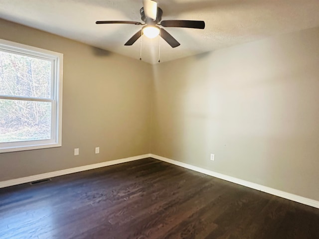 spare room featuring ceiling fan and dark hardwood / wood-style floors